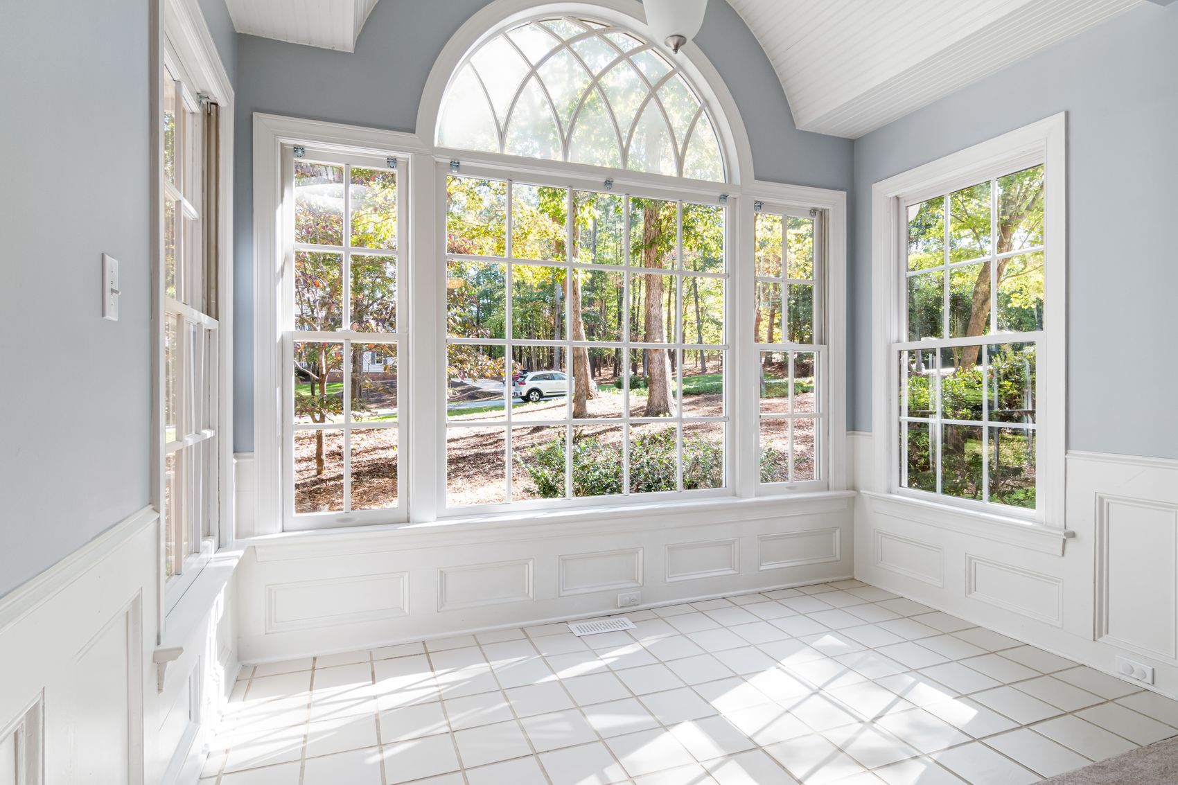 A bright garden room with an arched window