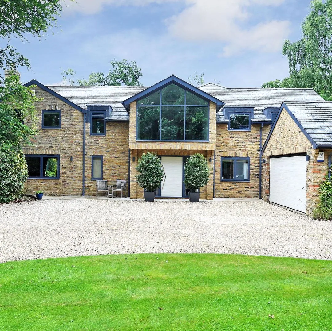 Brick home with anthracite-framed windows and a large glazed gable